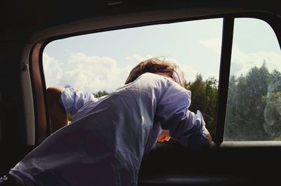 Rear view of man sitting in train