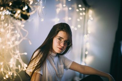 Portrait of woman in illuminated room