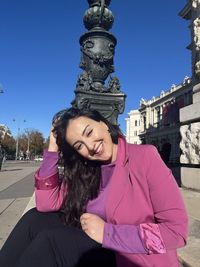 Low angle view of woman standing against sky