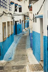 Empty alley amidst buildings in city