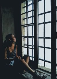 Woman looking through window