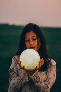 Portrait of woman holding ice cream cone