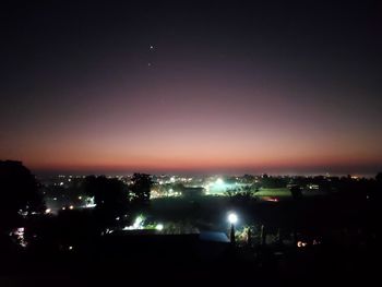 High angle view of illuminated buildings against sky at night