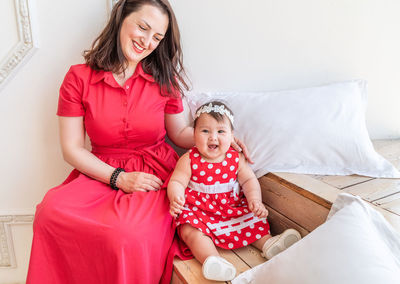 Portrait of smiling girl sitting at home