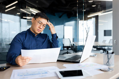 Businesswoman using laptop at office