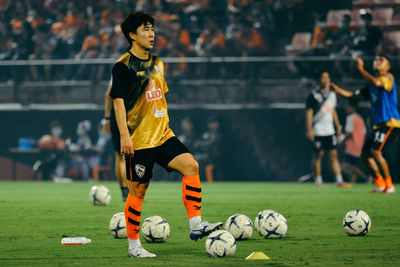 People playing soccer ball on field