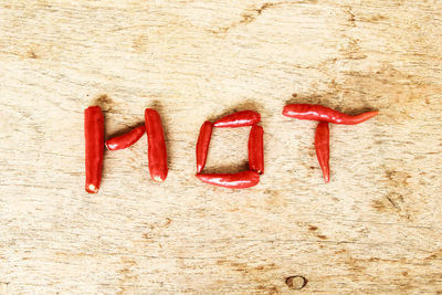 Directly above shot of hot text made with red chili peppers on table
