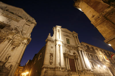 Low angle view of illuminated building at night