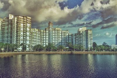 Skyscrapers against cloudy sky