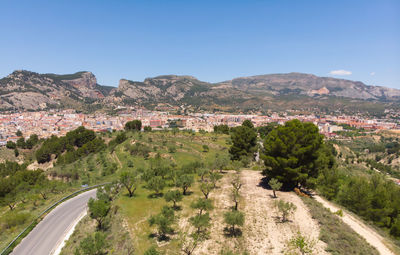 Scenic view of landscape and mountains against clear blue sky