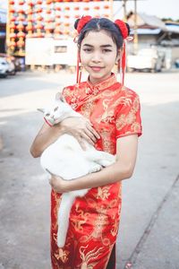 Portrait of smiling young woman in city