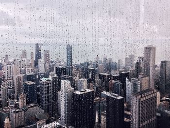 Cityscape seen through wet glass window