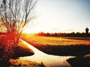Scenic view of field against sky during sunset
