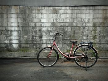 Bicycle parked against wall