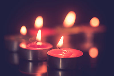 Close-up of illuminated tea light candles