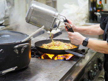 Cropped hand of man preparing food