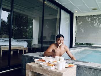 Portrait of a smiling young man in swimming pool