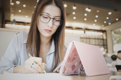 Portrait of young woman using mobile phone