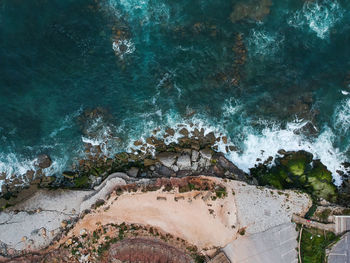 High angle view of water flowing through rocks