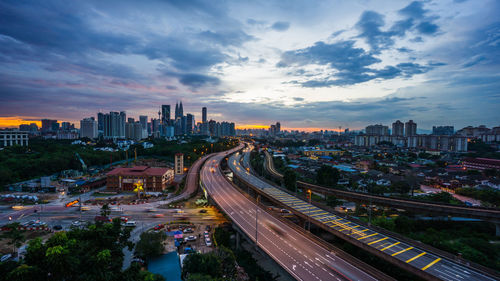 High angle view of city street and buildings against sky