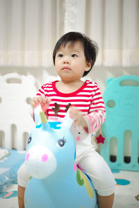 Cute baby boy at toy at home