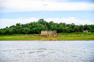 Scenic view of lake by building against sky