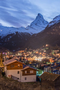 High angle view of townscape and mountains against sky