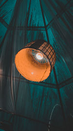 Low angle view of illuminated lantern hanging on wall