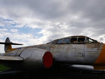 Abandoned airplane against sky