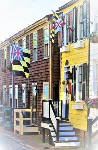 Multi colored flags on steps against sky