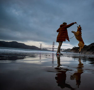Man standing on sea against sky