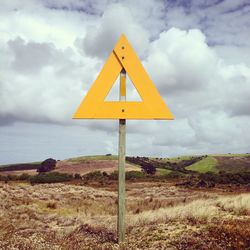 Information sign on landscape against sky