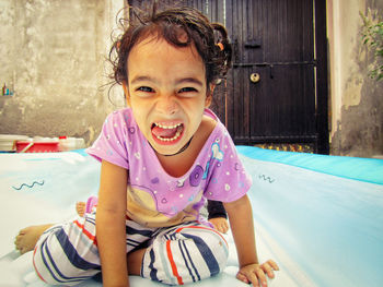 Portrait of smiling girl sitting sitting at home