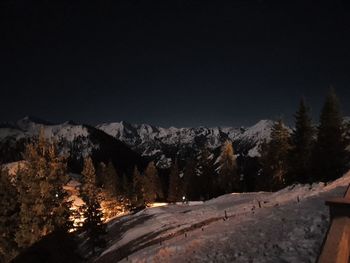 Scenic view of snowcapped mountains against sky at night