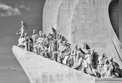 Statues against wall in city