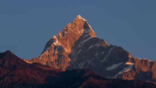 Low angle view of rocky mountain against sky