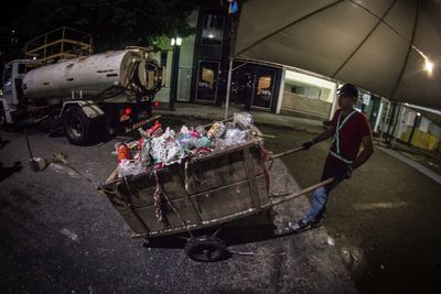 Man on garbage at night