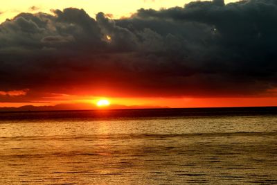 Scenic view of sea against romantic sky at sunset