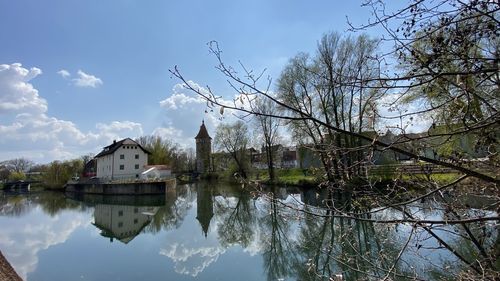 Reflection of trees and buildings in lake