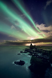 Scenic view of sea against sky at night