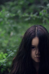 Close-up of beautiful woman against trees