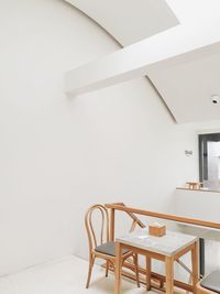 Empty chairs and table against wall at home