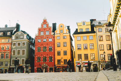 People standing in front of buildings in town