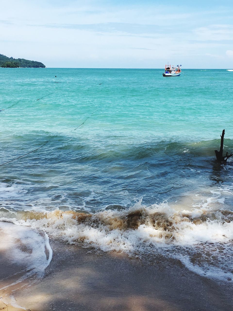 sea, water, horizon over water, beach, shore, scenics, tranquil scene, tranquility, sky, wave, beauty in nature, sand, nautical vessel, nature, idyllic, transportation, surf, vacations, mode of transport, boat