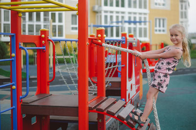 Full length of woman standing on red railing