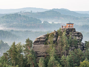 Breakfast during dawn in a restored gazebo on marrina rock. misty  bohemia switzerland national park