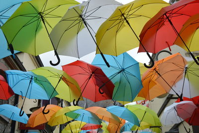 Full frame shot of multi colored umbrellas hanging in row