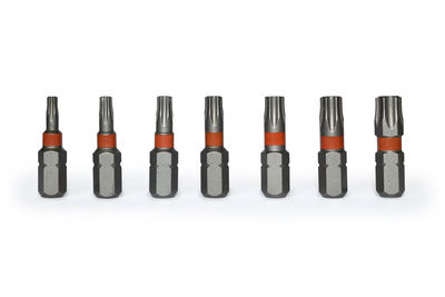 Close-up of colored pencils over white background