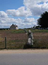 Built structure on field by building against sky