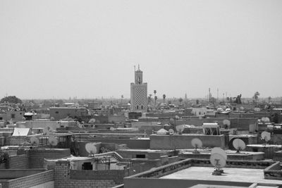 Buildings in city against clear sky